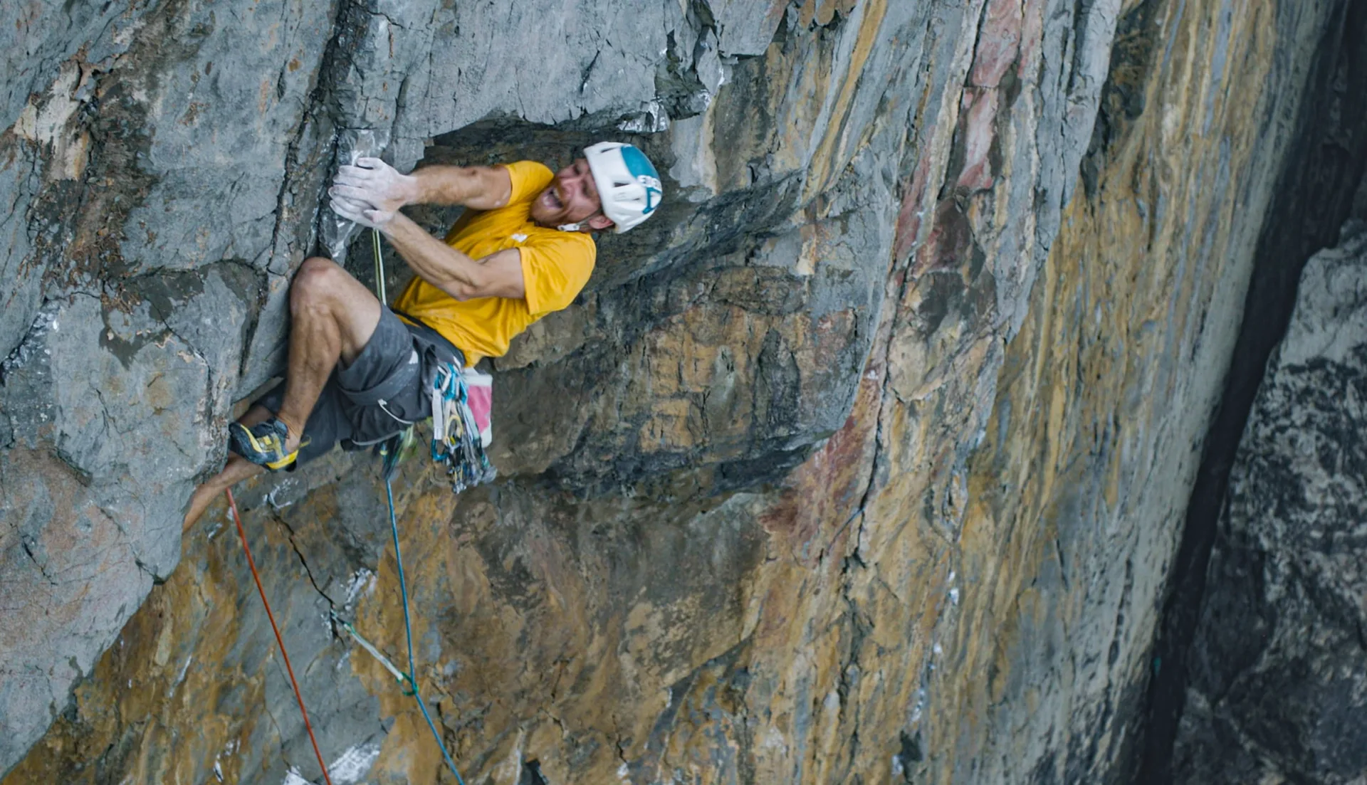 A climber finding a line on a sheer rock face